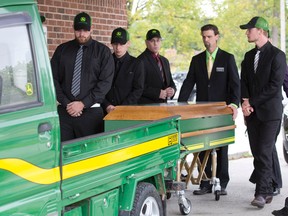 From pallbearers? caps to a green-and-yellow casket, Strathroy farmer Alex Rose was a John Deere fan to the end at his Ailsa Craig funeral Monday. (CRAIG GLOVER, The London Free Press)