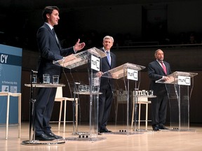 Liberal leader Justin Trudeau (L-R), Conservative leader and Prime Minister Stephen Harper and New Democratic Party (NDP) leader Thomas Mulcair are pictured during the Munk leaders' debate on Canada's foreign policy in Toronto, Canada September 28, 2015. Canadians go to the polls in a federal election on October 19, 2015. REUTERS/Fred Thornhill