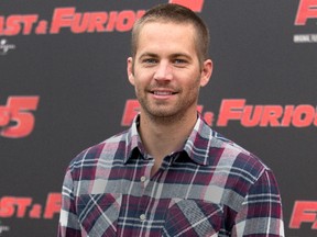 In this April 29, 2011, file photo, actor Paul Walker poses during the photo call of the movie "Fast and Furious 5," in Rome. Paul Walker’s daughter, Meadow Rain Walker, has filed a lawsuit Monday, Sept. 28, 2015, against Porsche, claiming the sports car that her father was a passenger in when he was killed in late 2013 suffered from numerous design defects. (AP Photo/Andrew Medichini, File)
