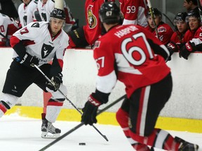 Carleton Ravens forward and former Ottawa 67 Ryan Van Stralen looks to make a move around BInghamton Senators defenceman Ben Harpur. (Chris Hofley/Ottawa Sun)