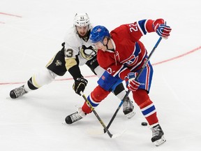 Nick Bonino #13 of the Pittsburgh Penguins challenges Dale Weise #22 of the Montreal Canadiens during an NHL pre-season game at the Videotron Centre on September 28, 2015 in Quebec City, Quebec, Canada.  Minas Panagiotakis/Getty Images/AFP