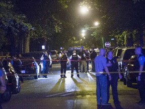 Police officers investigate a shooting scene where 5 people were reported to have been shot, including an 11-month-old infant, on September 28, 2015 in Chicago, Illinois. Chicago, like many major cities in the United States, has experienced a surge in shootings this year.  Scott Olson/Getty Images/AFP