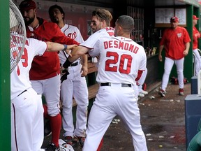 Bryce Harper #34 of the Washington Nationals is pulled away by Ian Desmond #20 after an altercation with Jonathan Papelbon #58 (not pictured) in the eighth inning against the Philadelphia Phillies at Nationals Park on September 27, 2015 in Washington, DC.   Greg Fiume/Getty Images/AFP