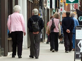 Senior citizens make their way down a street in Peterborough, Ont., on May 7, 2012. Statistics Canada says the country's population now features more seniors than children. (THE CANADIAN PRESS/Frank Gunn)