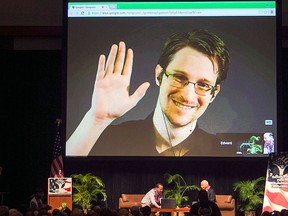 In this Feb. 14, 2015 file photo, Edward Snowden appears on a live video feed broadcast from Moscow at an event sponsored by ACLU Hawaii in Honolulu.  (AP Photo/Marco Garcia, File)