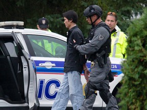 Ottawa Police arrest a man who barricaded himself for six hours in a rooming house on Belcourt Blvd. in Orleans on Tuesday September 29, 2015. Errol McGihon/Ottawa Sun/Postmedia Network