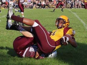 Regiopolis-Notre Dame Panthers’ Tyrell Downer gets upended by a Frontenac Falcons player during a Kingston Area senior football game at Regiopolis on Sept. 24. The Panthers won 16-15. (Ian MacAlpine/The Whig-Standard)