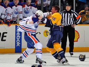 Rich Clune of the Nashville Predators fights Mike Brown of the Edmonton Oilers at Bridgestone Arena in Nashville on March 8, 2013. (Frederick Breedon/Getty Images/AFP)