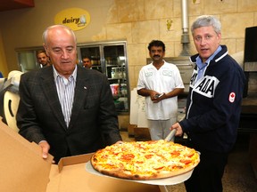 Prime Minister Stephen Harper (r) makes pizza in Woodbridge in the riding of Julian Fantino (l) on Tuesday September 29, 2015. (Michael Peake/Toronto Sun)