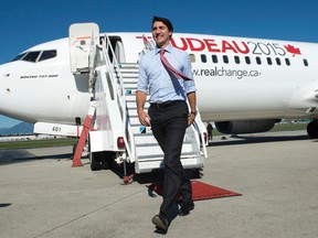 Liberal Leader Justin Trudeau walks on the tarmac away from the party's campaign plane in Vancouver on Tuesday, September 29, 2015. THE CANADIAN PRESS/Paul Chiasson