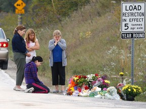 People gather to leave flowers at the spot where three children and their grandfather were killed in a crash with an alleged drunk driver on Sunday at Kipling and Kirby in Vaughan on Tuesday September 29, 2015. (Michael Peake/Toronto Sun)