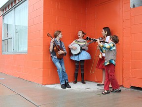 Noah, Muirden, Hannah and Ezra, children of members of the local band the Gertrudes, practise their parts for a video for the song Anglin Bay Blues outside the former Olympia Billiards building of Charles Street. (Patrick Kennedy/The Whig-Standard)