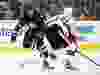 Winnipeg Jets' Dustin Byfuglien, left, tries to carry the puck past Ottawa Senators' Chris Wideman (45) during second period pre-season NHL hockey action in Winnipeg on Tuesday, September 29, 2015. THE CANADIAN PRESS/Trevor Hagan