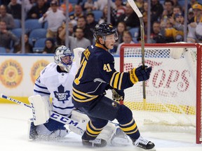 Buffalo Sabres forward Jack Eichel celebrates after scoring a goal while Toronto Maple Leafs goaltender Jonathan Bernier reacts during the first period of an NHL preseason hockey game, Tuesday, Sept. 29, 2015 in Buffalo, N.Y. (AP Photo/Gary Wiepert)