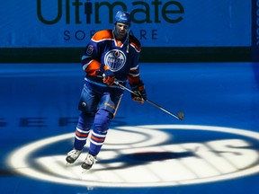 Griffin Reinhart skates on the ice during player introductions before Tuesday's game against the Coyotes at Rexall Place. (Ian Kucerak, Edmotnon Sun)
