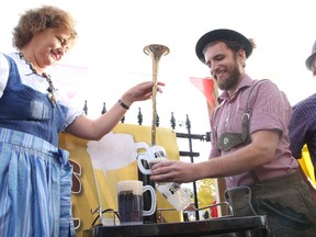 German language teacher Jenny (Sachsalber) Moutsatsos and Stack Brewing brewmaster Michael Guillemette tap the keg to launch Northern Lights Oktoberfest in Sudbury, Ont. on Tuesday September 29, 2015. The event takes place on Oct. 2 and 3 at Bell Park.Gino Donato/Sudbury Star/Postmedia Network