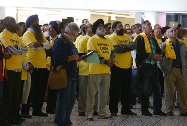 Taxi industry people watch the debate over Uber in the overflow area in the main rotunda as the council chambers were closed Wednesday September 30, 2015. (Michael Peake/Toronto Sun)