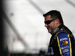Tony Stewart, driver of the #14 Code 3 Associates/Mobil 1 Chevrolet, stands in the garage area during practice for the NASCAR Sprint Cup Series Sylvania 300 at New Hampshire Motor Speedway in Loudon, N.H., on Sept. 26, 2015. (Jeff Zelevansky/Getty Images/AFP)