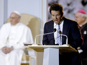 Pope Francis (L) listens to actor Mark Wahlberg speak at the Festival of Families in Philadelphia September 26, 2015.  REUTERS/POOL