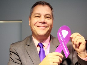 SARAH HYATT/THE INTELLIGENCER
Highland Shores Children's Aid executive director Mark Kartusch, encourages community members to sport a purple ribbon and show their support for kids during Child Abuse Prevention Month.