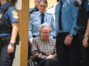 Former Quebec lieutenant governor Lise Thibault is escorted by agents, leaving the courtroom after receiving an 18-month prison sentence, Wednesday, September 30, 2015 at the courthouse in Quebec City. THE CANADIAN PRESS/Jacques Boissinot