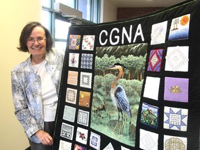 Theresa Lawrence displays a compilation of different work by members of the Cataraqui Guild of Needle Arts in Kingston. The members of the guild are holding a fair on Saturday to showcase their work. Vendors will be selling craft supplies. (Michael Lea/The Whig-Standard)