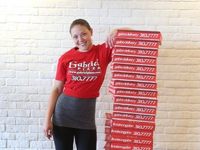 Pro pizza box maker Breanna Gray poses for a photo at Gabriel Pizza in Ottawa Ontario Wednesday Sept 30, 2015. Breanna has a viral Yoputube video of her quickly making pizza boxes.  Tony Caldwell/Ottawa Sun/Postmedia Network