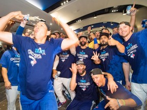 Toronto Blue Jays celebrate in the clubhouse after clinching a Wild Card spot in the playoffs on Sept. 26. (OTHE CANADIAN PRESS)