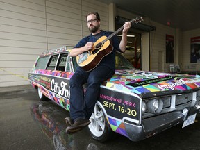 Ottawa Sun reporter Aedan Helmer plays his guitar on the City Folk car in Ottawa Ontario Tuesday Sept 29, 2015. Helmer wrote and performed a song for artist Sun Kil Moon. Tony Caldwell/Ottawa Sun/Postmedia Network