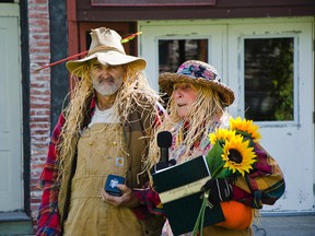 Francis Cyr (left) and his wife Colleen Cyr (right) were dressed in their “incognito” outfits during the Harvest Festival held at the Kootenai Brown Pioneer Village. Officials and townsfolk celebrated the pair’s 10 years of volunteer service during the Sept. 19 ceremony.