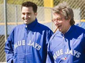 Toronto Blue Jays GM Alex Anthopoulos and president Paul Beeston talk during workouts at the team's spring training facility in Dunedin, Fla., on February 17, 2013. (REUTERS/Fred Thornhill)