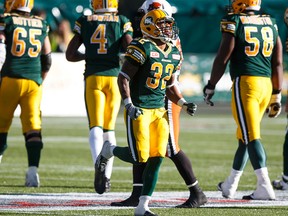 Edmonton's Kendial Lawrence (32) appears injured after a tackle during the second half of CFL action between the Edmonton Eskimos and the BC Lions at Commonwealth Stadium in Edmonton, Alta.. on Saturday September 26, 2015. Ian Kucerak/Edmonton Sun/Postmedia Network