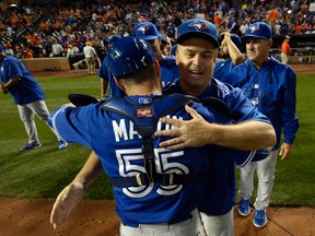 Blue Jays catcher Russell Martin (55) hugs manager John Gibbons as they celebrate on the field after clinching the AL East Division in Baltimore on Wednesday, Sept. 30, 2015. (Tommy Gilligan/USA TODAY Sports)