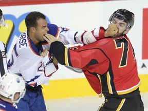 Darnell Nurse fights with Calgary Flames' Hunter Smith during the preseason split-squad game at the Scotiabank Saddledome Sept. 21 (Stuart Dryden, Postmedia Network)