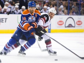 Arizona Coyotes' Brad Hunt, right, and Edmonton Oilers' Jordan Eberle (14) battle for the puck during first period NHL pre-season action in Edmonton on Tuesday, September 29, 2015. THE CANADIAN PRESS/Jason Franson