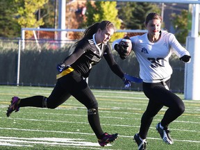Cassidy Burton, of the Marymount Academy Regals dodges a Lively Hawks player as she makes a run with the ball during girls flag football action from James Jerome Field in Sudbury, Ont. on Wednesday September 30, 2015.