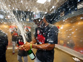 St. Louis Cardinals’ Jason Heyward pops the cork on a bottle of champagne after the Cardinals clinched the Central Division in Pittsburgh, Wednesday, Sept. 30, 2015. (AP Photo/Gene J. Puskar)