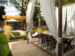 Back yard renovation at the London home of Martha Huk and James Blokker features a dining area, fire pit and hot tub. (MIKE HENSEN, The London Free Press)