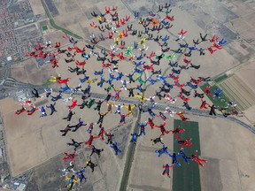 This Tuesday, Sept. 29, 2015 photo provided by Craig O'Brien shows a record-breaking skydiving formation above Perris, Calif. Two-hundred-and-two skydivers from around the world set the record when they all linked up thousands of feet above Southern California. The group formed the largest sequential skydiving formation. (Craig O'Brien via AP)