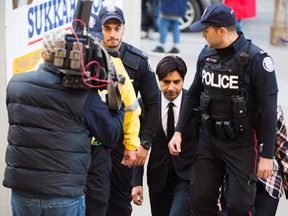 Former CBC radio host Jian Ghomeshi, centre, arrives to appear for a pre-trial hearing for his sexual assault case on Thursday, Oct. 1, 2015. (The Canadian Press)