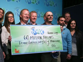 Twelve Markham co-workers collected their $60 million Lotto Max jackpot on Thursday Oct. 1, 2015. (VERONICA HENRI/Toronto Sun)