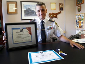 EMILY MOUNTNEY-LESSARD/THE INTELLIGENCER
Belleville Police Deputy Chief Ron Gignac sits in his office with two certificates and a medal presented last week by the The Métis Nation of Ontario Veterans’ Council.