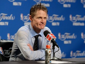 Head coach Steve Kerr of the Golden State Warriors speaks in overtime the media after they defeated the Cleveland Cavaliers in Game Six of the 2015 NBA Finals at Quicken Loans Arena on June 16, 2015 in Cleveland, Ohio. Jason Miller/Getty Images/AFP