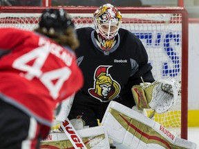 Ottawa Senators goaltender Andrew Hammond makes a save off of J.G. Pageau during team practice at the Canadian Tire Centre in Ottawa, Ont. on Tuesday September 22, 2015. Errol McGihon/Ottawa Sun/Postmedia Network