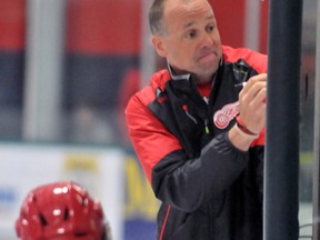 Detroit Red Wings coach Jeff Blashill, top, uses a white board to instruct moves during NHL hockey training camp in Traverse City, Mich., Sept 18, 2015. (AP Photo/ John L. Russell)