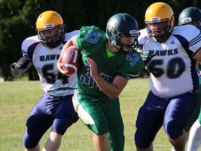 Mitch Damchuk of the St. Pat's Fighting Irish carries the ball up the field with Chatham-Kent Golden Hawks players Jacob Dodman and Nic Melillo pursuing him during the teams' senior boy's high school football game Thursday afternoon in Sarnia. The Irish won 10-0. (Terry Bridge, The Observer)