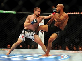 Demetrious Johnson (red) fights against Ali Bagautinov (blue) in the flyweight title bout at UFC 174 at Rogers Arena in Vancouver on June 14, 2014. (Anne-Marie Sorvin/USA TODAY Sports)