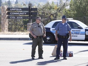 Police officers stand guard near the site of a mass shooting at Umpqua Community College in Roseburg, Oregon October 1, 2015. A gunman opened fire at a community college in southern Oregon on Thursday, killing 13 people and wounding some 20 others before he was shot to death by police, state and county officials said, in the latest mass killing to rock a U.S. school. There were conflicting reports on the number of dead and wounded in the shooting rampage in Roseburg, which began shortly after 10:30 a.m. local time (1730 GMT).  REUTERS/Steve Dipaola