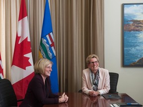 Ontario Premier Kathleen Wynne (right) meets with Alberta Premier Rachel Notley at Queen's Park in Toronto, Thursday, Oct, 1, 2015. THE CANADIAN PRESS/Marta Iwanek