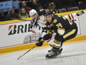 Justin Scott of the Barrie Colts shoots the puck past Sarnia Sting defenceman Kevin Spinozzi during the Ontario Hockey League game at Barrie Molson Centre Thursday night. Sarnia shut out Barrie 1-0. (Mark Wanzel, Postmedia Network)